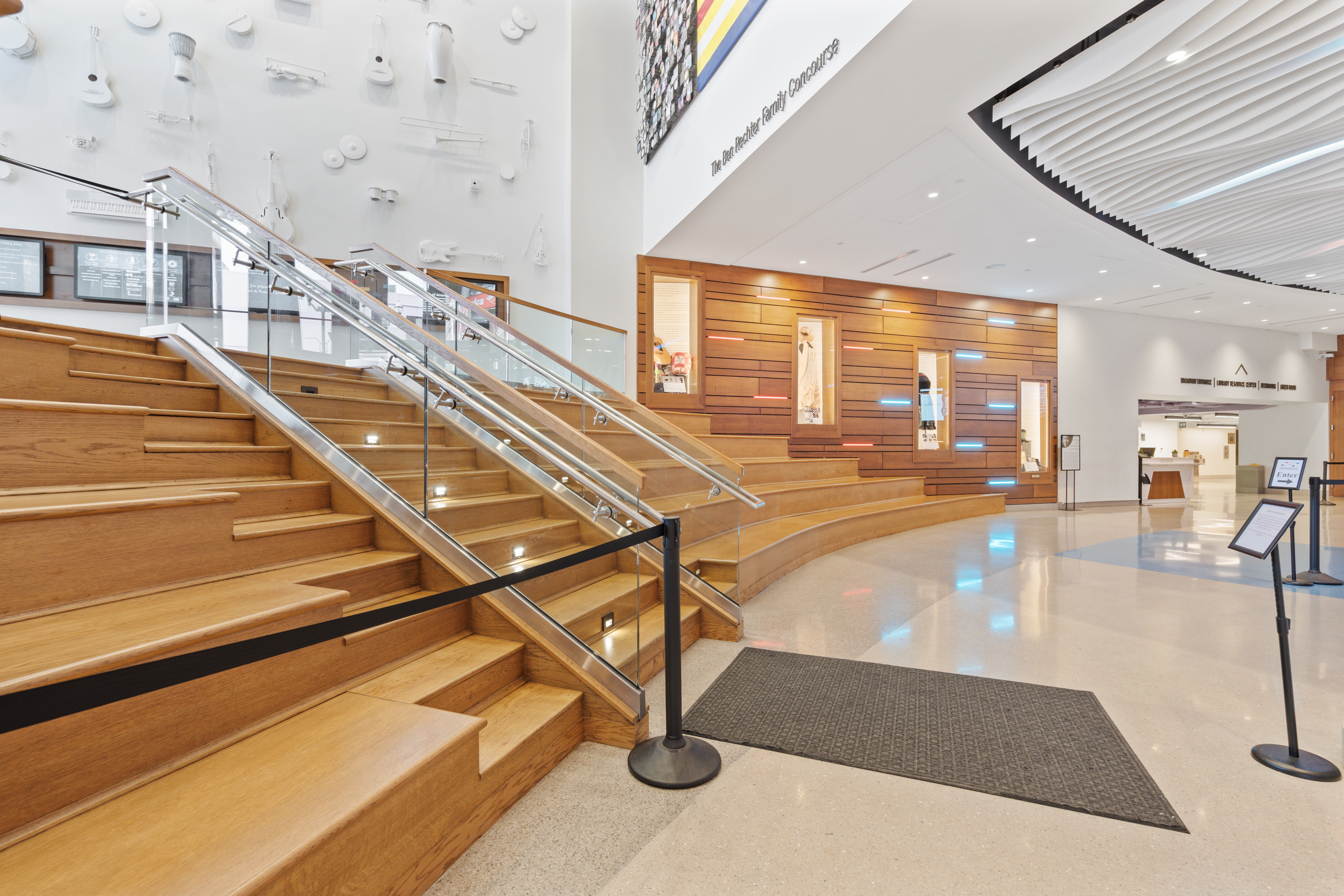 Wooden staircase and instrument wall in the Ben Rechter Family Concourse at the National Museum of African American Music